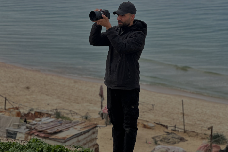 Camera operator filming by the sea