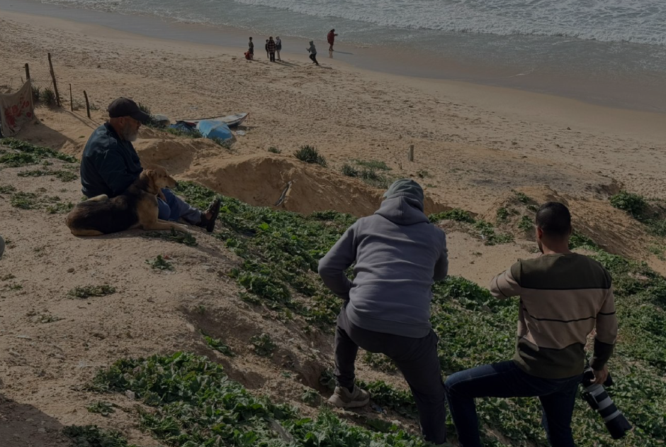 Crew filming on the dunes above the beach