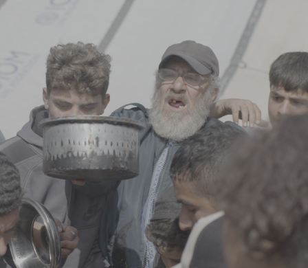 Salem waiting in a crowd holding a pot