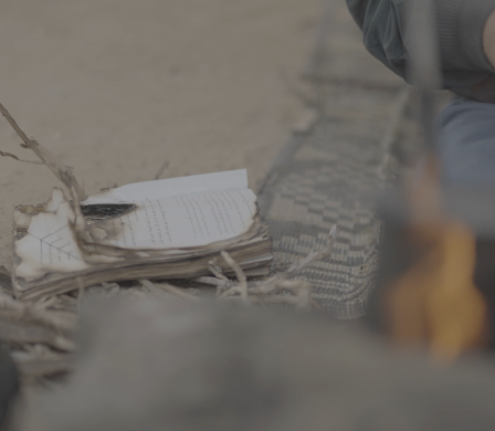 Pages beside a small fire